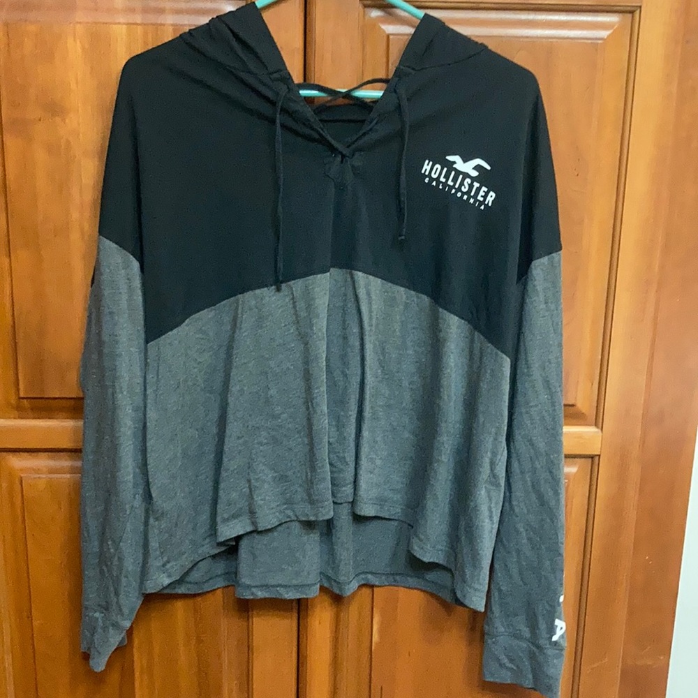 Long sleeve Hollister shirt with hood and white lettering.Adjustable strings too